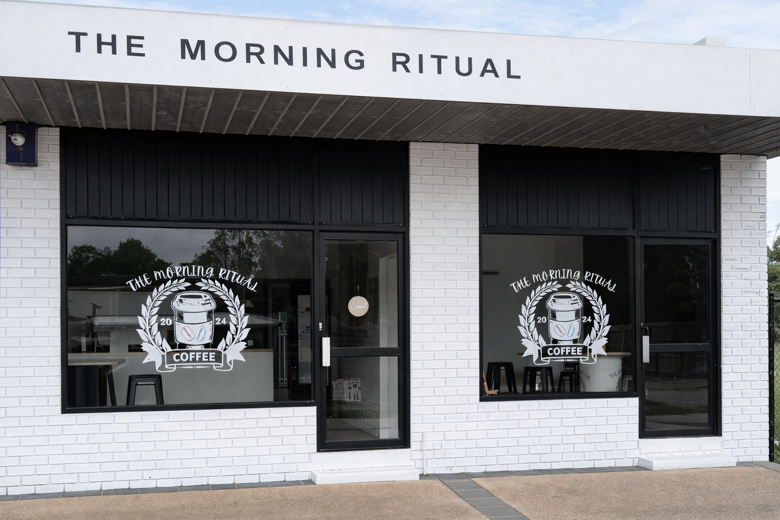 Exterior of The Morning Ritual cafe with signage and logo window decals