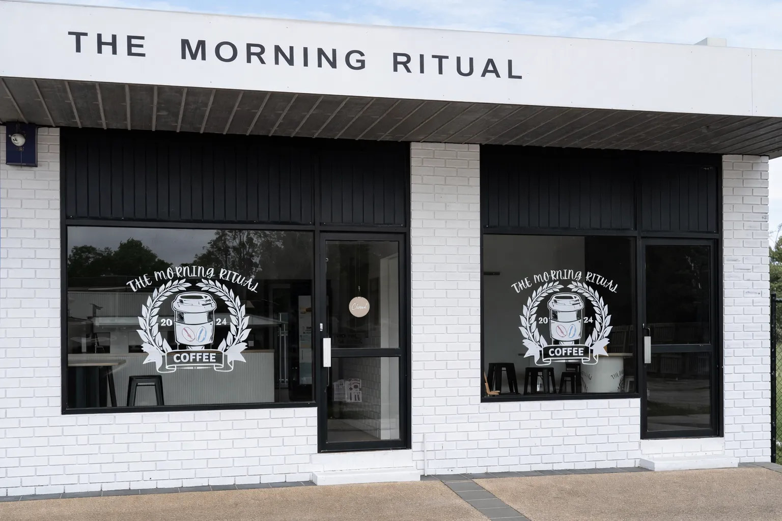 Exterior of The Morning Ritual cafe with signage and logo window decals